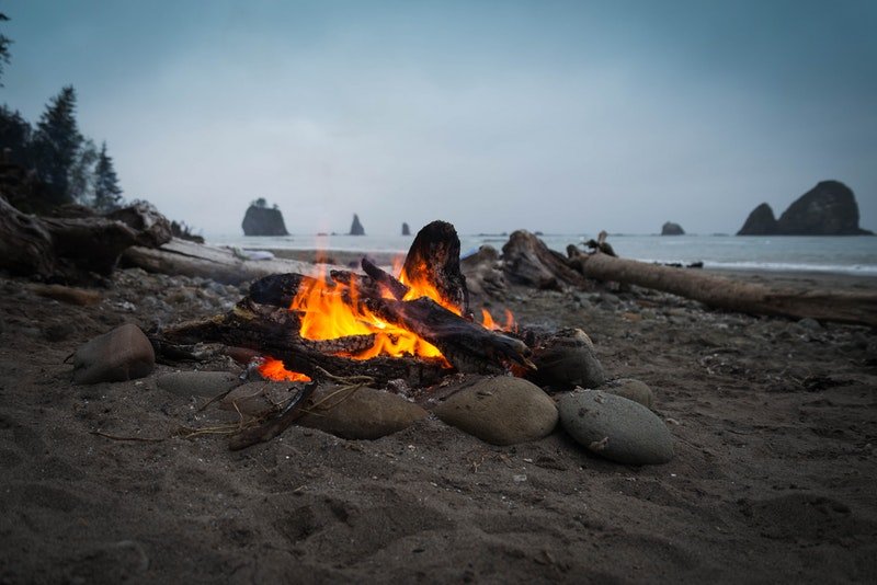 A fire on the shore of a beach